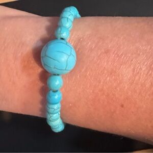 Sky Blue Beaded Bracelet with Central Knot Design